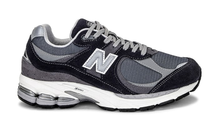 Side view of a grey and black New Balance sneaker.